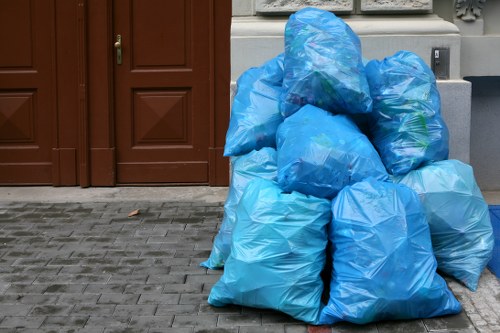 Worker carrying labeled boxes during a Sydenham flat clearance